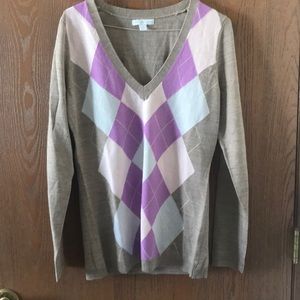 Brown sweater with blue and purple on the front.